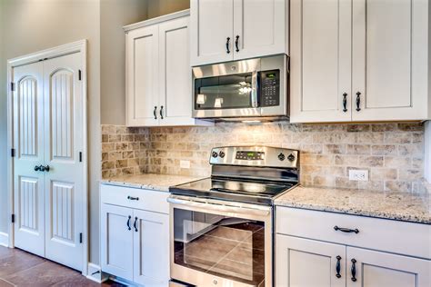 stainless steel appliances in a kitchen with white cabinets|stainless steel off white kitchen.